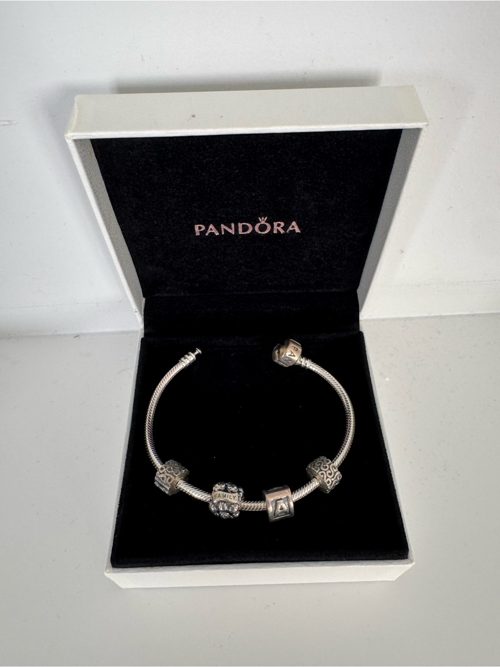 Pandora Sterling Silver Charm Bracelet with 2 Silver Charms and 2 clip charms.